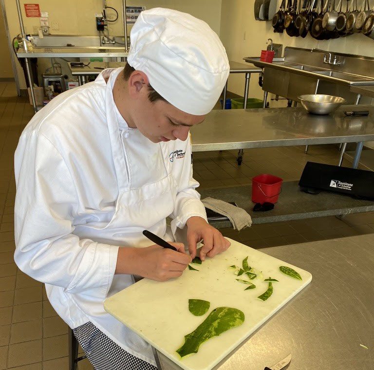 Student cutting shapes out of watermelon skin