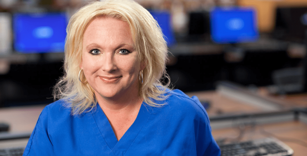 Woman in scrubs smiling