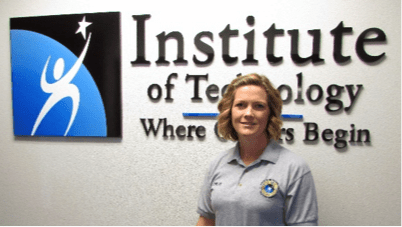Woman standing in front of Institute of Technology sign