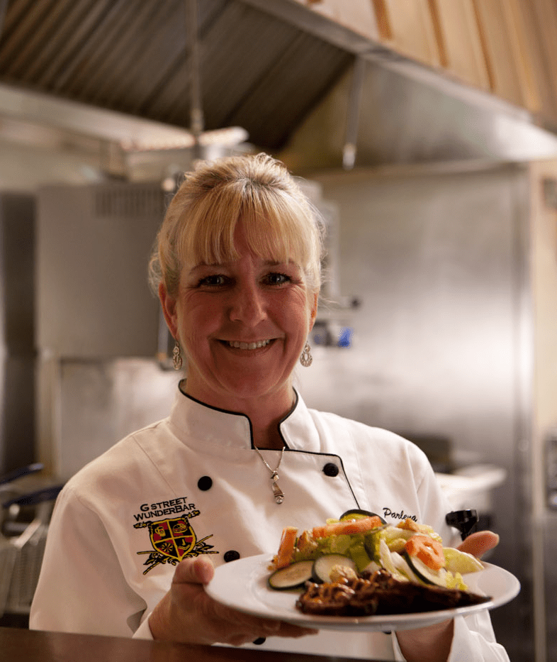 Woman smiling holding dinner plate