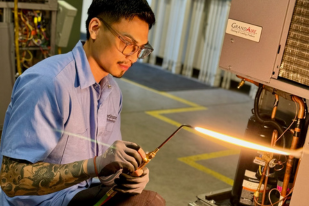 nstitute of Technology HVAC student receiving hands-on heating, ventilation, and air conditioning training in a modern lab.