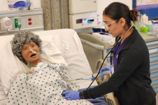 Institute of Technology Vocational Nursing student practicing patient care skills in a hands-on clinical lab.